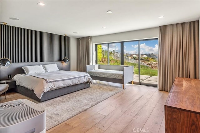 bedroom featuring light hardwood / wood-style floors and access to outside