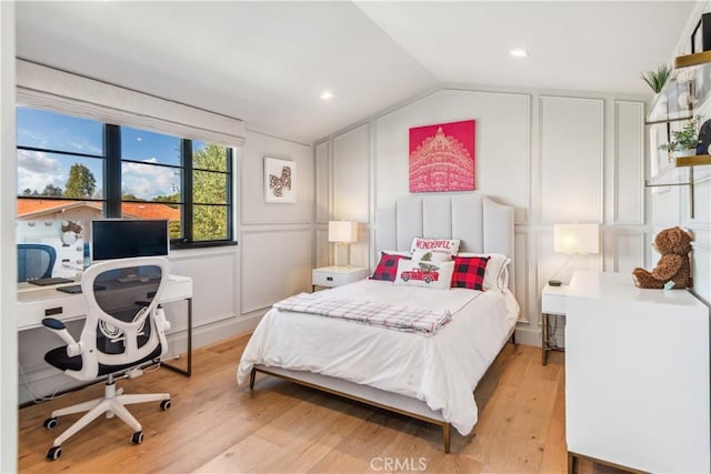 bedroom featuring light hardwood / wood-style floors and vaulted ceiling