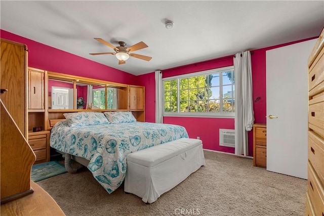 carpeted bedroom with ceiling fan, a wall mounted AC, and vaulted ceiling