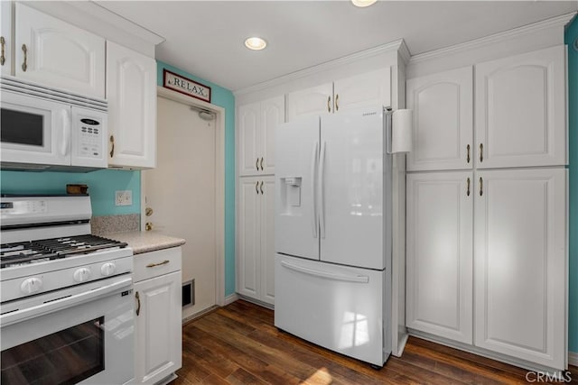 kitchen featuring dark hardwood / wood-style floors, white appliances, and white cabinetry