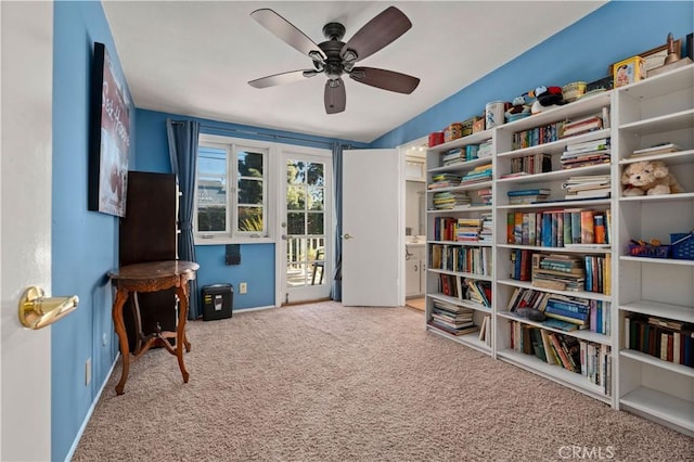 sitting room with ceiling fan and carpet