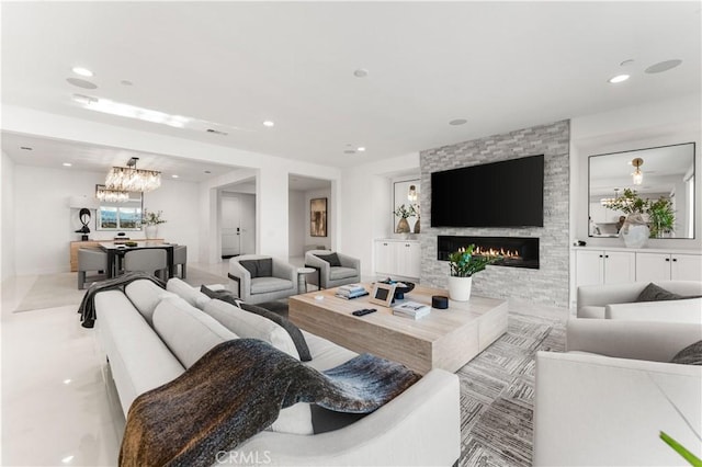 living room featuring a fireplace and a chandelier