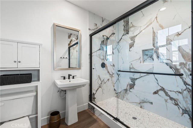 bathroom featuring hardwood / wood-style flooring, toilet, and an enclosed shower