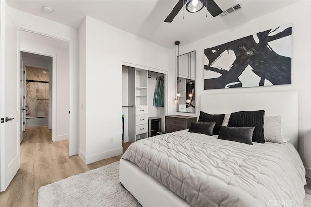 bedroom featuring a closet, light hardwood / wood-style flooring, and ceiling fan