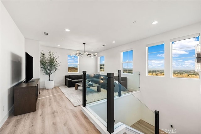 interior space featuring light hardwood / wood-style floors and an inviting chandelier