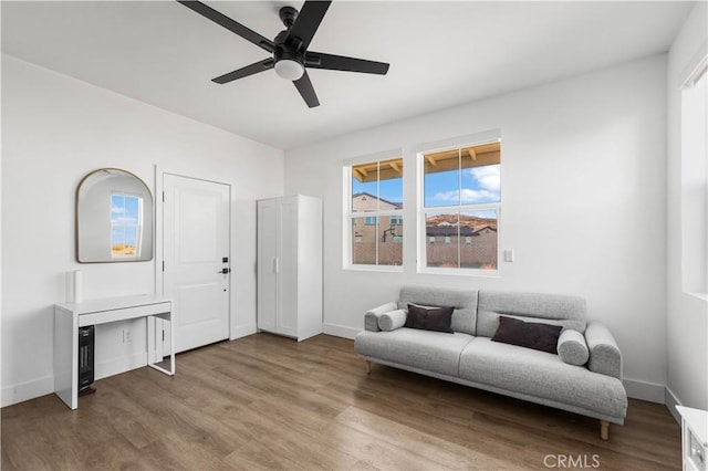 sitting room featuring ceiling fan and hardwood / wood-style flooring