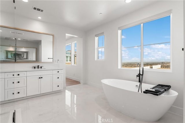 bathroom featuring a tub and vanity