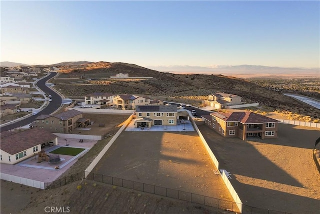 aerial view at dusk featuring a mountain view