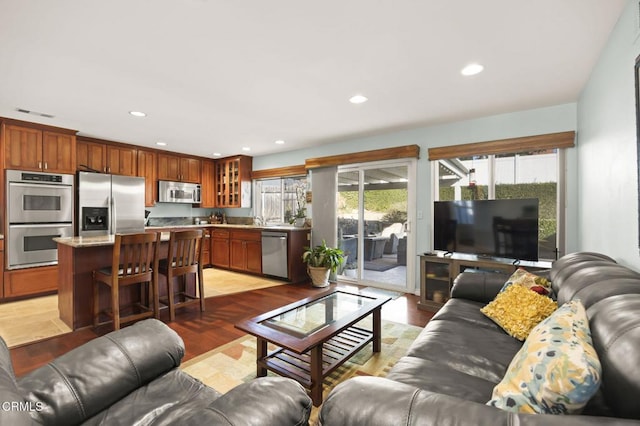 living room with light wood-type flooring and sink