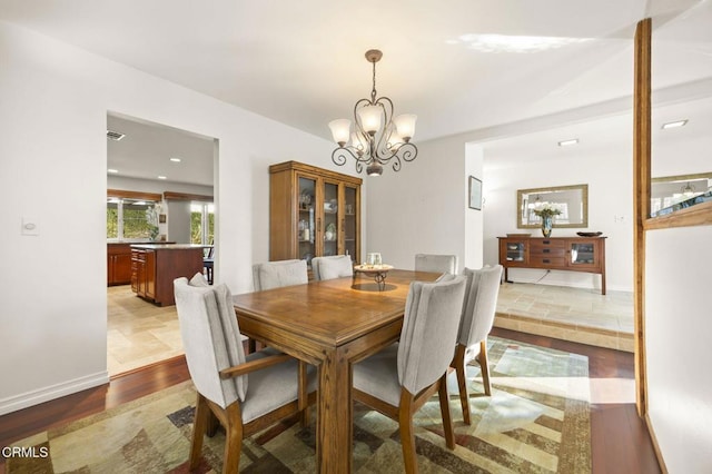 dining area with a chandelier and light hardwood / wood-style floors