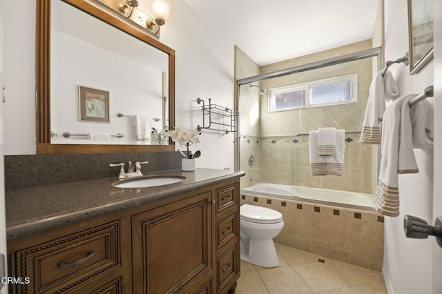 full bathroom with tiled shower / bath combo, vanity, toilet, and tile patterned flooring