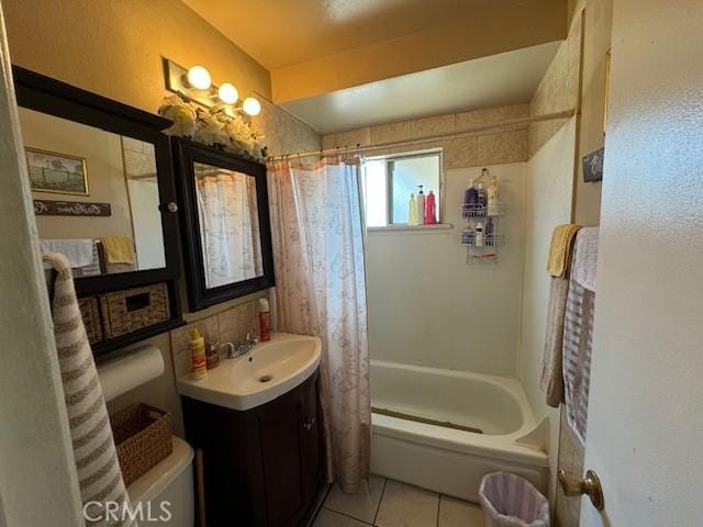 full bathroom featuring toilet, shower / bath combo with shower curtain, vanity, and tile patterned flooring