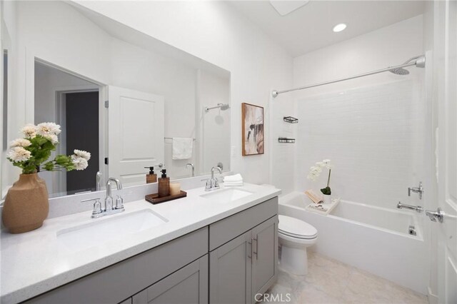 full bathroom with shower / bathing tub combination, vanity, tile patterned flooring, and toilet