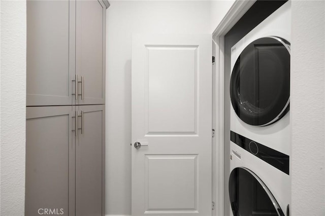 washroom with stacked washer and clothes dryer