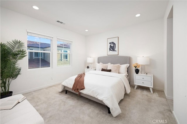 bedroom with light colored carpet