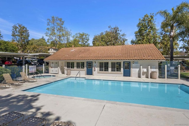 view of pool featuring a patio area and a community hot tub