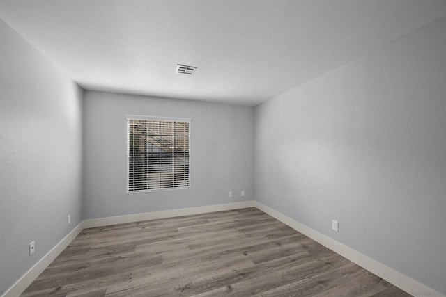 empty room with hardwood / wood-style flooring