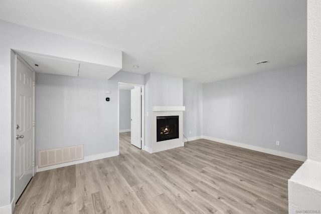 unfurnished living room with light hardwood / wood-style flooring