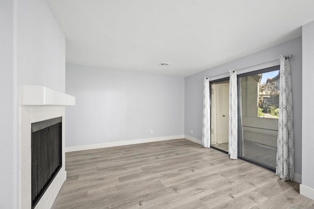 unfurnished living room with light hardwood / wood-style flooring