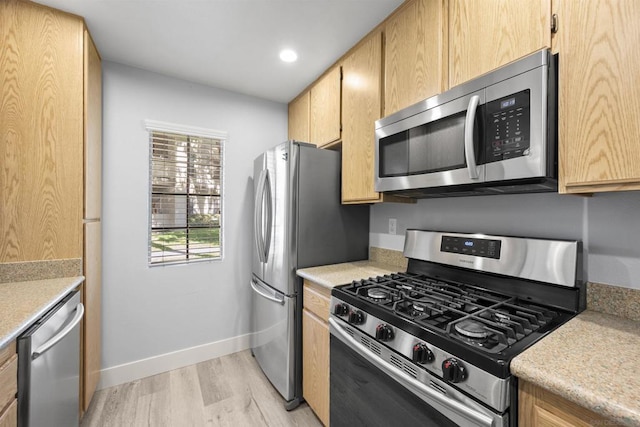 kitchen featuring light wood-type flooring and stainless steel appliances