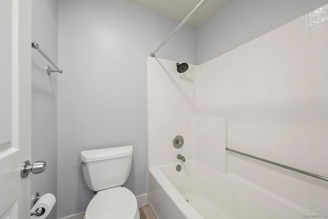 bathroom with washtub / shower combination and toilet