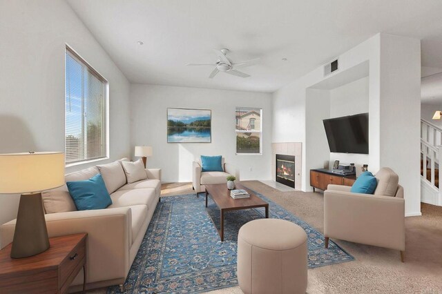 living room featuring ceiling fan, carpet flooring, and a fireplace