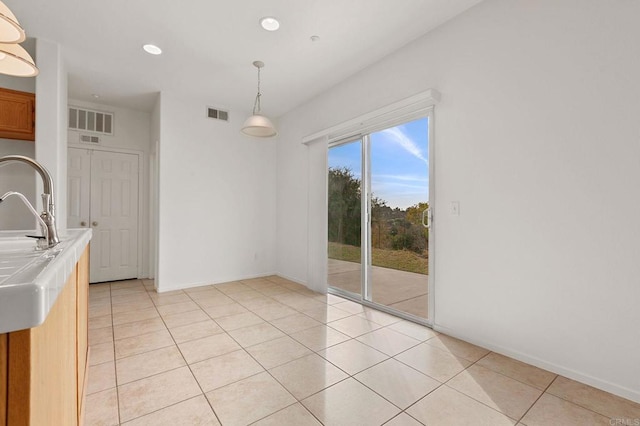 unfurnished dining area with light tile patterned flooring