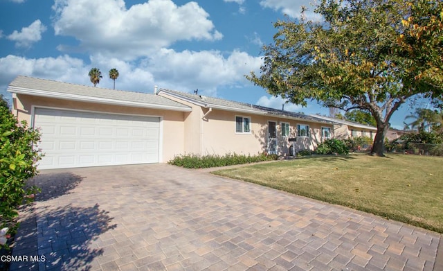 ranch-style house featuring a front yard and a garage