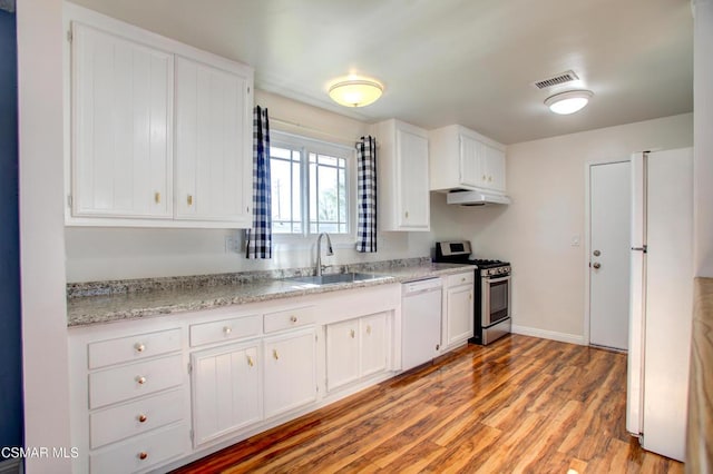 kitchen featuring white appliances, light hardwood / wood-style flooring, white cabinetry, and sink