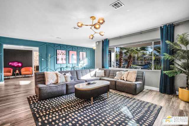 living room featuring light hardwood / wood-style floors and a notable chandelier