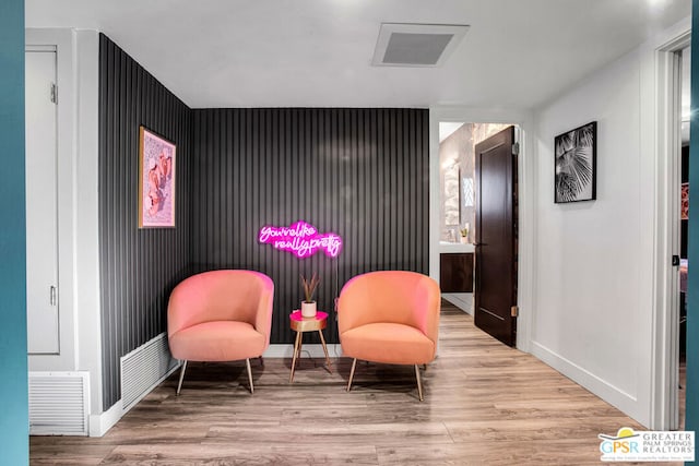 sitting room featuring light hardwood / wood-style flooring