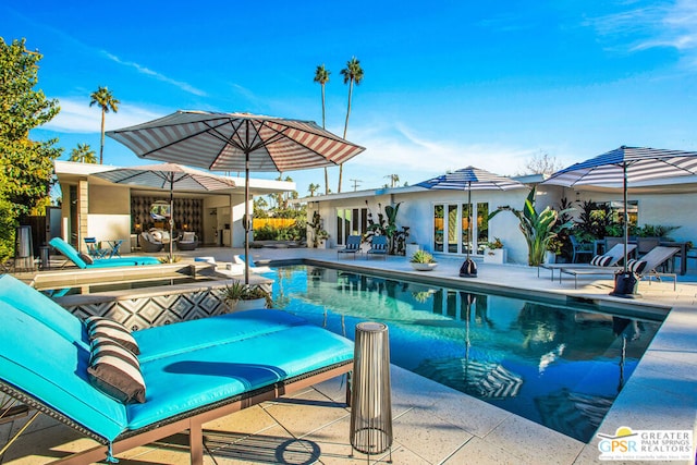 view of pool with a patio area and french doors