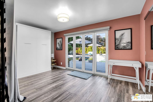 doorway to outside featuring french doors and light hardwood / wood-style floors