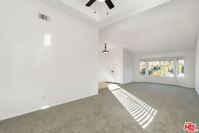 unfurnished living room featuring ceiling fan, carpet floors, and lofted ceiling