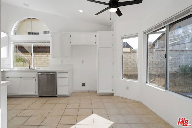 kitchen featuring sink, dishwasher, white cabinetry, lofted ceiling, and light tile patterned flooring