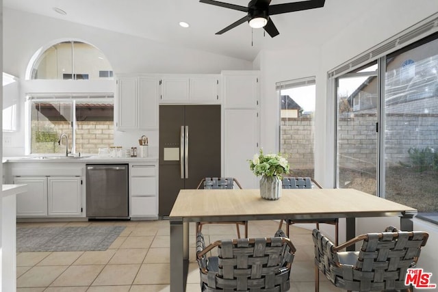 kitchen with dishwasher, lofted ceiling, black refrigerator with ice dispenser, sink, and white cabinetry