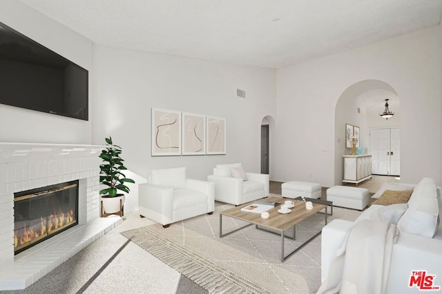 carpeted living room featuring a fireplace