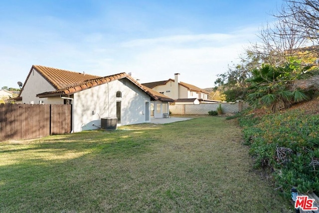 view of yard with a patio and central AC unit