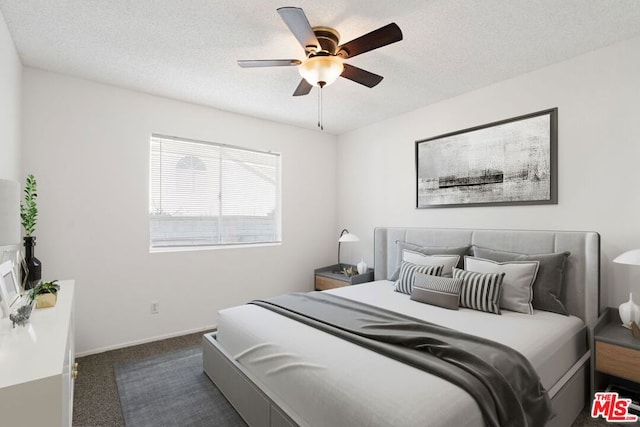 carpeted bedroom featuring a textured ceiling and ceiling fan