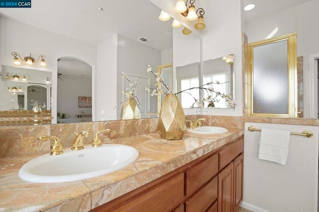 bathroom featuring ceiling fan, walk in shower, and vanity