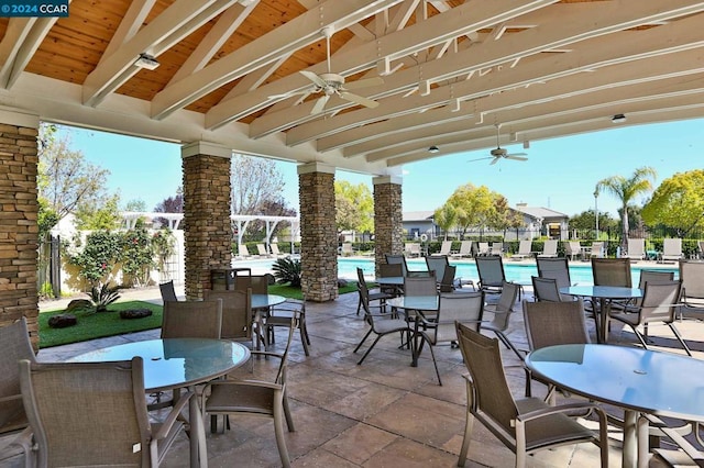 view of patio featuring ceiling fan and a community pool