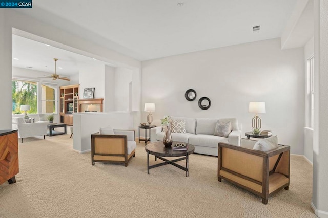 living room with ceiling fan and light colored carpet