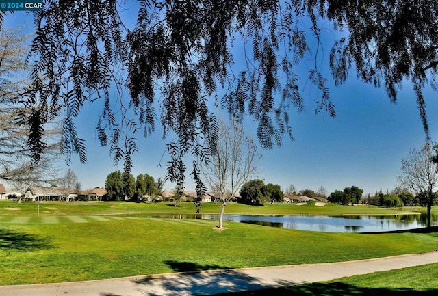 view of property's community with a yard and a water view