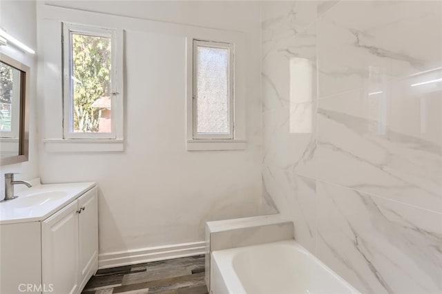 bathroom featuring hardwood / wood-style floors, vanity, and a bath