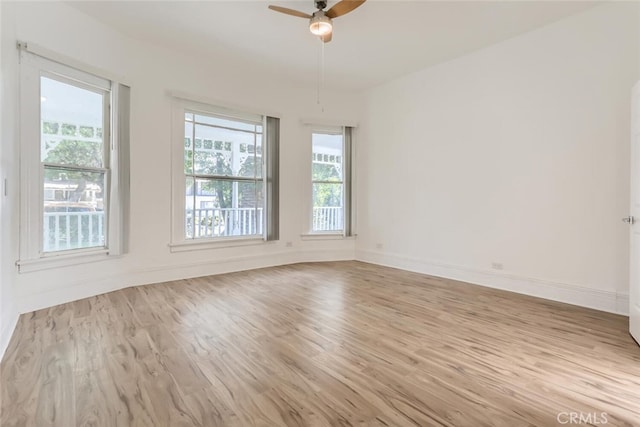 empty room featuring light hardwood / wood-style flooring and ceiling fan