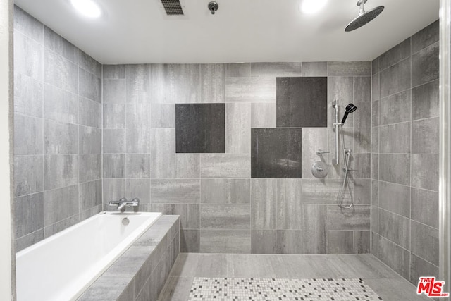 bathroom featuring tile patterned flooring, separate shower and tub, and tile walls