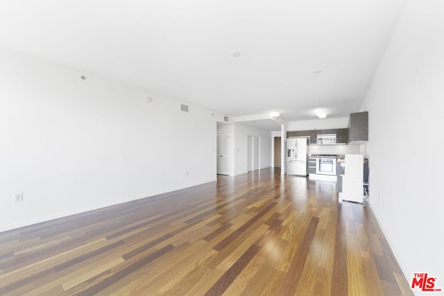 unfurnished living room with dark hardwood / wood-style flooring