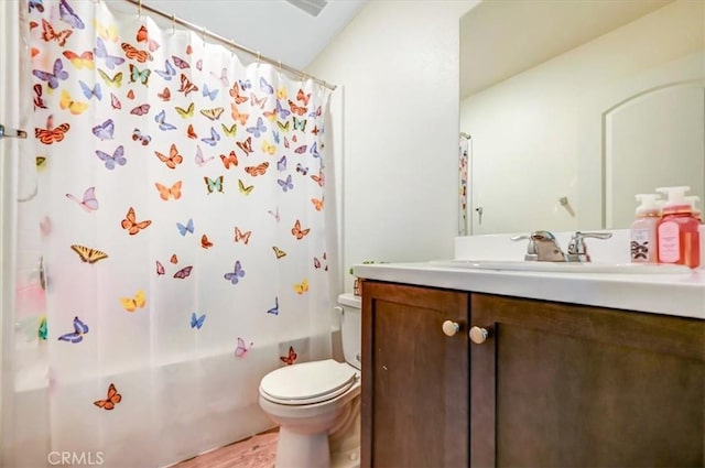 full bathroom with hardwood / wood-style floors, vanity, toilet, and shower / bathtub combination with curtain