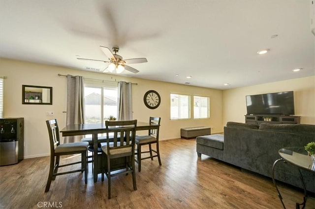 dining space with plenty of natural light, dark wood-type flooring, and ceiling fan