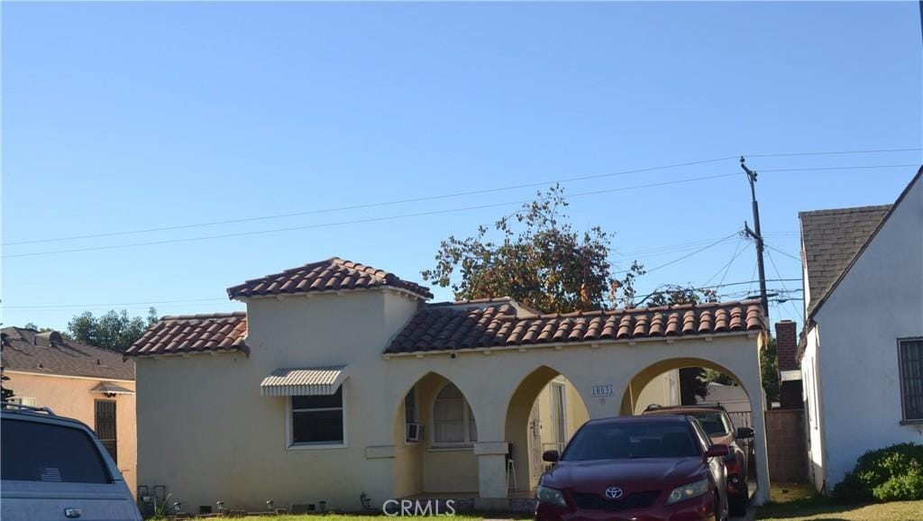 mediterranean / spanish-style home with a front lawn